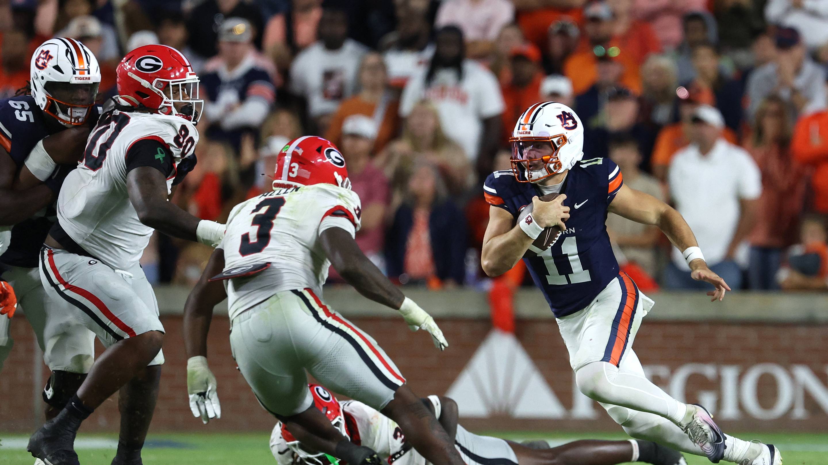 Oct 11, 2025; Auburn, Alabama, USA; Auburn Tigers quarterback Jackson Arnold (11) carries during the fourth quarter against the Georgia Bulldogs at Jordan-Hare Stadium. Mandatory Credit: John Reed-Imagn Images
