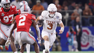 Jan 10, 2025; Arlington, Texas, USA; Texas Longhorns quarterback Quinn Ewers (3) runs against Ohio State Buckeyes safety Caleb Downs (2) during the second quarter of the College Football Playoff semifinal in the Cotton Bowl at AT&T Stadium. Mandatory Credit: Tim Heitman-Imagn Images