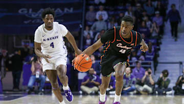Jan 29, 2025; Manhattan, Kansas, USA; Oklahoma State Cowboys guard Davonte Davis (4) dribbles by Kansas State Wildcats guard Mobi Ikegwuruka (4) guard Mobi Ikegwuruka (4) during the first half at Bramlage Coliseum. Mandatory Credit: Scott Sewell-Imagn Images