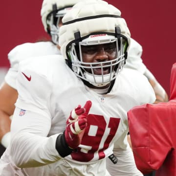 Arizona Cardinals defensive lineman L.J. Collier (91) runs through a drill during training camp at State Farm Stadium in Glendale, Ariz., on Monday, July 29, 2024.