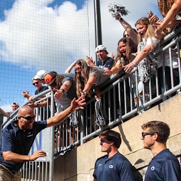 Penn State football coach James Franklin celebrates with students after a Nittany Lions victory at Beaver Stadium.