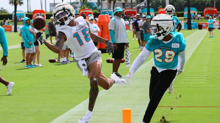 Miami Dolphins wide receiver Erik Ezukanma (18) catches the football against cornerback Kendall Fuller (29) during training camp at Baptist Health Training Complex.