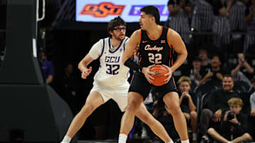 Dec 6, 2025; Phoenix, Arizona, USA;  Grand Canyon Lopes forward Wilhelm Breidenbach (32) plays defense on Oklahoma State Cowboys forward Parsa Fallah (22) at PHX Arena. Mandatory Credit: Anna Carrington-Imagn Images
