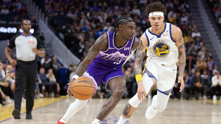 Apr 14, 2024; San Francisco, California, USA; Utah Jazz guard Kira Lewis Jr. (13) drives past Golden State Warriors guard Lester Quinones (25) during the fourth quarter at Chase Center. Mandatory Credit: D. Ross Cameron-USA TODAY Sports