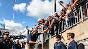 Penn State football coach James Franklin celebrates with students following a Nittany Lions victory at Beaver Stadium.