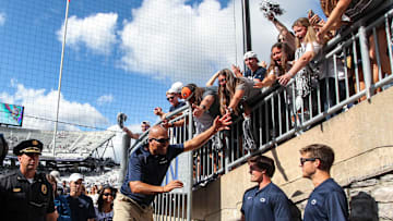 Penn State football coach James Franklin celebrates with students following a game at Beaver Stadium. 