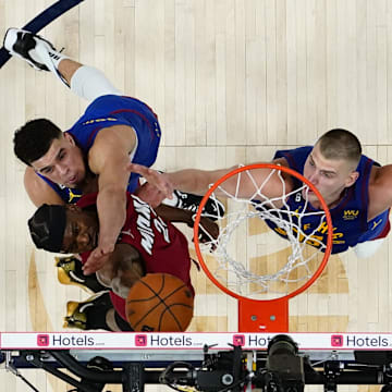 Miami Heat forward Jimmy Butler (22) against Denver Nuggets forward Michael Porter Jr. and center Nikola Jokic during the 2023 NBA Finals at Ball Arena. 