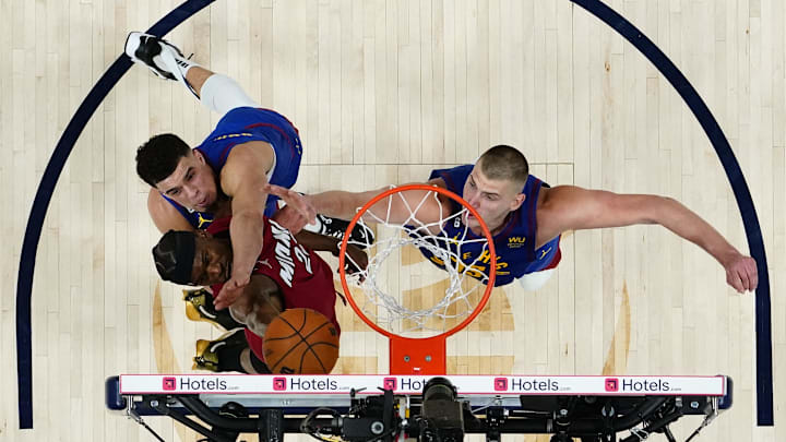 Miami Heat forward Jimmy Butler (22) against Denver Nuggets forward Michael Porter Jr. and center Nikola Jokic during the 2023 NBA Finals at Ball Arena. 