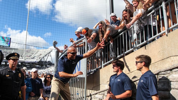 Penn State football coach James Franklin celebrates wit students after a win at Beaver Stadium.