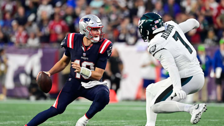 Sep 10, 2023; Foxborough, Massachusetts, USA; New England Patriots quarterback Mac Jones (10) tries to avoid Philadelphia Eagles linebacker Haason Reddick (7) during the second half at Gillette Stadium.