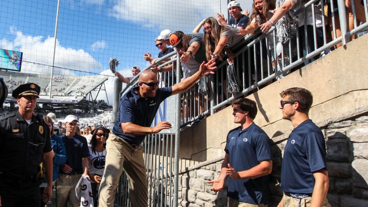 Penn State football coach James Franklin celebrates with students following a Nittany Lions victory at Beaver Stadium. 