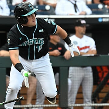 Jun 15, 2025; Omaha, Neb, USA;  Coastal Carolina Chanticleers catcher Caden Bodine (17) reaches on an infield error by the Oregon State Beavers during the first inning at Charles Schwab Field.