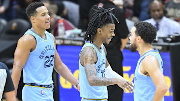 Jan 4, 2022; Cleveland, Ohio, USA; Memphis Grizzlies guard Desmond Bane (22) and guard Ja Morant (12) and Memphis Grizzlies guard Tyus Jones (21) celebrate in the fourth quarter against the Cleveland Cavaliers at Rocket Mortgage FieldHouse. Mandatory Credit: David Richard-Imagn Images