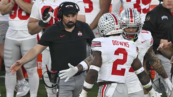 Jan 1, 2025; Pasadena, CA, USA;  Ohio State Buckeyes head coach Ryan Day greets safety Caleb Downs as he returns to the bench during the third quarter at Rose Bowl Stadium. Mandatory Credit: Robert Hanashiro-Imagn Images