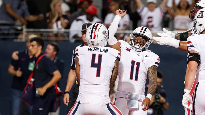 Aug 31, 2024; Tucson, Arizona, USA; Arizona Wildcats wide receiver Tetairoa McMillan (4) celebrates a touchdown with Arizona Wildcats quarterback Noah Fifita (11) against the New Mexico Lobos during the first quarter at Arizona Stadium. Mandatory Credit: Aryanna Frank-Imagn Images