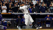 New York Yankees outfielder Aaron Judge (99) hits a two-run home run during the first inning against the Los Angeles Dodgers in game five of the 2024 MLB World Series at Yankee Stadium. 
