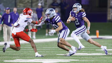 Sep 13, 2024; Manhattan, Kansas, USA; Kansas State Wildcats quarterback Avery Johnson (2) follows the block by wide receiver Keagan Johnson (10) on Arizona Wildcats defensive back Tacario Davis (1) during the third quarter at Bill Snyder Family Football Stadium. Mandatory Credit: Scott Sewell-Imagn Images