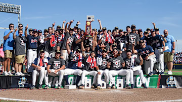 Jun 26, 2022; Omaha, NE, USA;  The Ole Miss Rebels celebrate with the championship trophy after the victory against the Oklahoma Sooners at Charles Schwab Field. Mandatory Credit: Steven Branscombe-Imagn Images