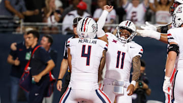 Aug 31, 2024; Tucson, Arizona, USA; Arizona Wildcats wide receiver Tetairoa McMillan (4) celebrates a touchdown with Arizona Wildcats quarterback Noah Fifita (11) against the New Mexico Lobos during the first quarter at Arizona Stadium. 