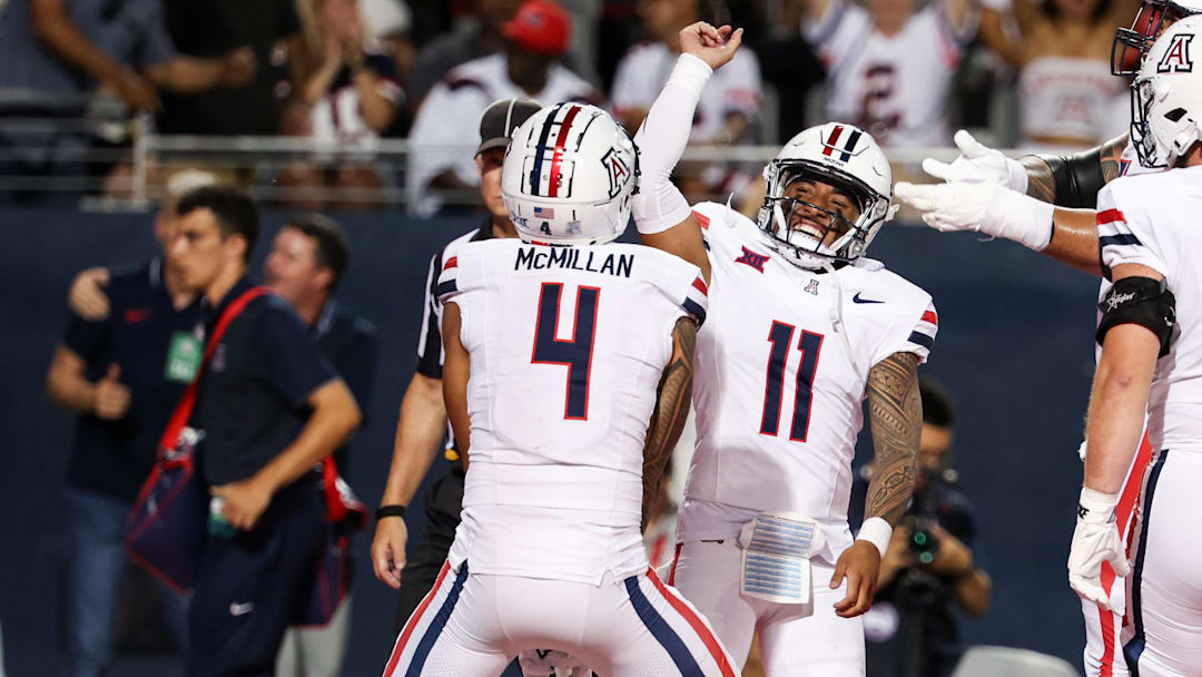 Aug 31, 2024; Tucson, Arizona, USA; Arizona Wildcats wide receiver Tetairoa McMillan (4) celebrates a touchdown with Arizona Wildcats quarterback Noah Fifita (11) against the New Mexico Lobos during the first quarter at Arizona Stadium. 