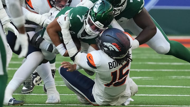 Oct 12, 2025; Tottenham, United Kingdom; New York Jets quarterback Justin Fields (7) is tackled by Denver Broncos linebacker Nik Bonitto (15) during an NFL International Series game at Tottenham Hotspur Stadium. Oct 12, 2025; Tottenham, United Kingdom; New York Jets quarterback Justin Fields (7) is tackled by Denver Broncos linebacker Nik Bonitto (15) during an NFL International Series game at Tottenham Hotspur Stadium.