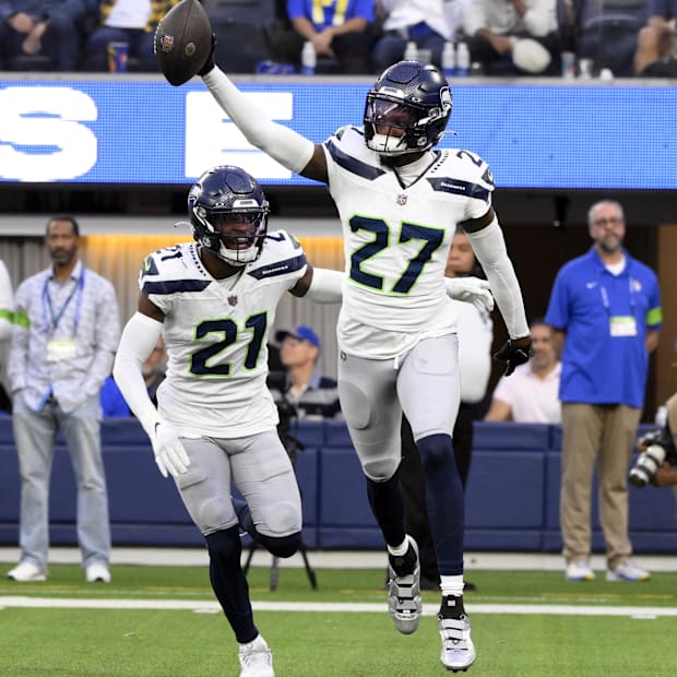 Seattle Seahawks cornerback Riq Woolen celebrates making an interception against the Los Angeles Rams.