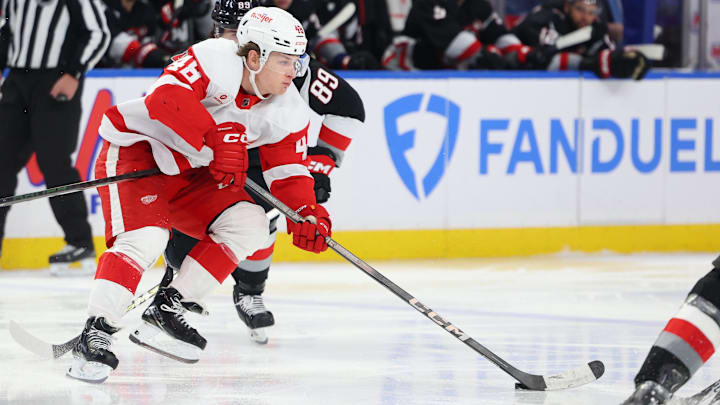 Mar 12, 2024; Buffalo, New York, USA;  Detroit Red Wings right wing Jonatan Berggren (48) skates with the puck and looks to make a pass during the third period against the Buffalo Sabres at KeyBank Center. Mandatory Credit: Timothy T. Ludwig-Imagn Images