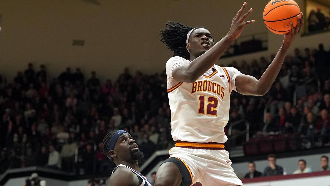 Feb 14, 2026; Santa Clara, California, USA; Santa Clara Broncos center Bukky Oboye (12) shoots against Gonzaga Bulldogs forward Graham Ike (center left) during the first half at Leavey Center. Mandatory Credit: Darren Yamashita-Imagn Images