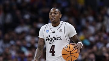 Mar 22, 2025; Denver, CO, USA; Texas A&M Aggies guard Wade Taylor IV (4) dribbles the ball against the Michigan Wolverines during the second half in the second round of the NCAA Tournament  at Ball Arena. Mandatory Credit: Isaiah J. Downing-Imagn Images