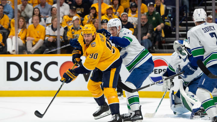 May 3, 2024; Nashville, Tennessee, USA; Nashville Predators center Ryan O'Reilly (90) passes the puck against the Vancouver Canucks during the first period in game six of the first round of the 2024 Stanley Cup Playoffs at Bridgestone Arena. Mandatory Credit: Steve Roberts-USA TODAY Sports