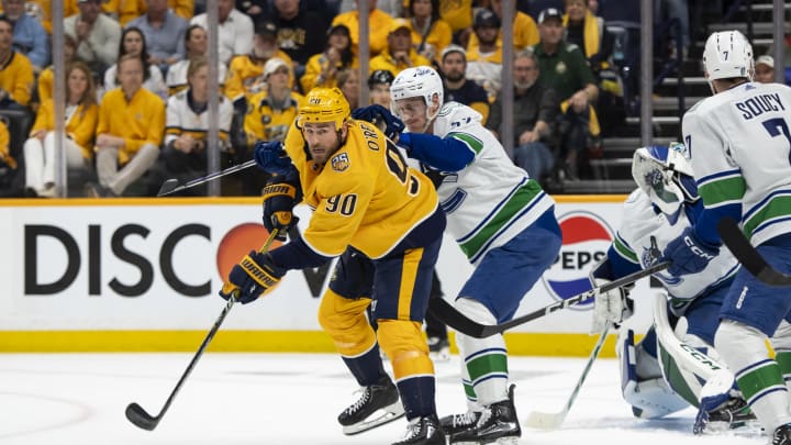 May 3, 2024; Nashville, Tennessee, USA; Nashville Predators center Ryan O'Reilly (90) passes the puck against the Vancouver Canucks during the first period in game six of the first round of the 2024 Stanley Cup Playoffs at Bridgestone Arena. Mandatory Credit: Steve Roberts-USA TODAY Sports