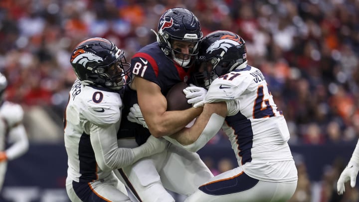 Dec 3, 2023; Houston, Texas, USA; Houston Texans tight end Eric Saubert (81) runs with the ball after a reception as Denver Broncos linebacker Jonathon Cooper (0) and Denver Broncos linebacker Josey Jewell (47) attempt to make a tackle during the third quarter at NRG Stadium. Mandatory Credit: Troy Taormina-USA TODAY Sports