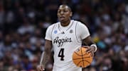 Mar 22, 2025; Denver, CO, USA; Texas A&M Aggies guard Wade Taylor IV (4) dribbles the ball against the Michigan Wolverines during the second half in the second round of the NCAA Tournament  at Ball Arena. Mandatory Credit: Isaiah J. Downing-Imagn Images