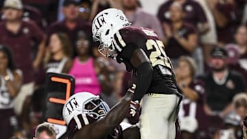 Oct 11, 2025; College Station, Texas, USA; Texas A&M Aggies defensive tackle Albert Regis (17) hoists safety Dalton Brooks (25) after he recovered a fumble in the third quarter against the Florida Gators at Kyle Field. Mandatory Credit: Maria Lysaker-Imagn Images 