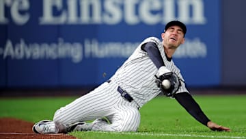 Oct 8, 2025; Bronx, New York, USA; New York Yankees left fielder Cody Bellinger (35) slides to makes a catch during the first inning against the Toronto Blue Jays during game four of the ALDS round for the 2025 MLB playoffs at Yankee Stadium. Mandatory Credit: Brad Penner-Imagn Images