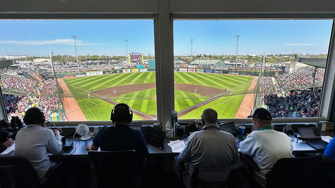 The ABS operator sits in the press box at LECOM Park during a spring training game.