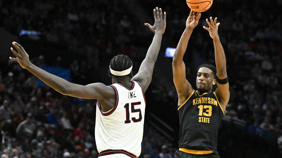 Mar 19, 2026; Portland, OR, USA; Kennesaw State Owls forward Braedan Lue (13) shoots against Gonzaga Bulldogs forward Graham Ike (15) during the first half of a first round game of the men's 2026 NCAA Tournament at Moda Center. Mandatory Credit: Craig Strobeck-Imagn Images