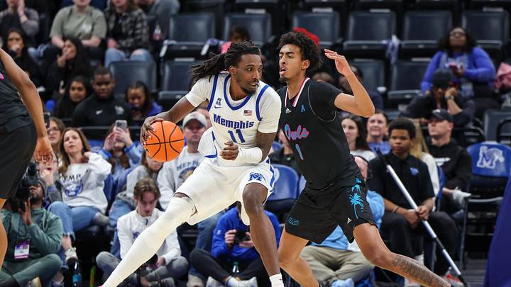Jan 29, 2026; Memphis, Tennessee, USA; Memphis Tigers forward Aaron Bradshaw (11) drives against Florida Atlantic Owls forward Devin Williams (1) during the second half at FedExForum. Mandatory Credit: Wesley Hale-Imagn Images