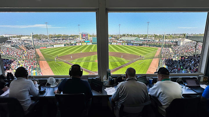 The ABS operator sits in the press box at LECOM Park during a spring training game.