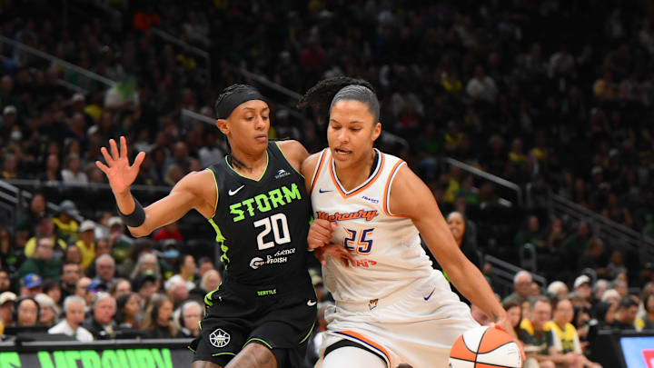 Aug 17, 2025; Seattle, Washington, USA; Phoenix Mercury forward Alyssa Thomas (25) plays the ball while guarded by Seattle Storm guard Brittney Sykes (20) during the first half at Climate Pledge Arena. Mandatory Credit: Steven Bisig-Imagn Images