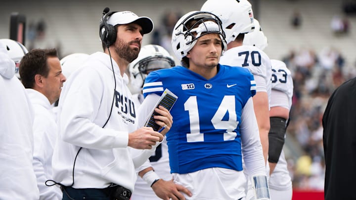 Penn State quarterback Jaxon Smolik (14) talks with quarterback coach Danny O'Brien on the sideline during the Blue-White game at Beaver Stadium on Saturday, April 26, 2025, in State College. The White team defeated the Blue team, 10-8.