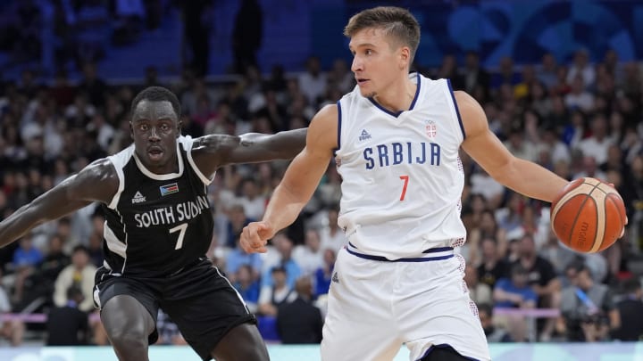 Aug 3, 2024; Villeneuve-d'Ascq, France; Serbia shooting guard Bogdan Bogdanovic (7) dribbles against South Sudan shooting guard Bul Kuol (7) in the fourth quarter during the Paris 2024 Olympic Summer Games at Stade Pierre-Mauroy.