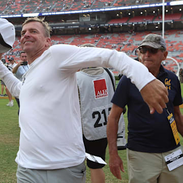 Cal head coach Justin Wilcox celebrates with fans after beating Auburn