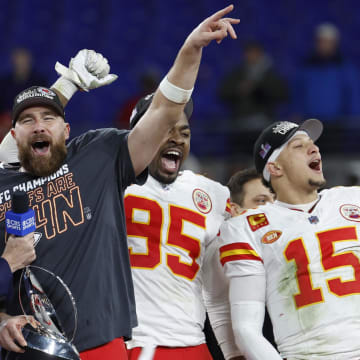 Jan 28, 2024; Baltimore, Maryland, USA; Kansas City Chiefs tight end Travis Kelce (M) celebrates with the Lamar Hunt trophy next to Chiefs defensive tackle Chris Jones (95) and Chiefs quarterback Patrick Mahomes (15) while speaking with CBS broadcaster Jim Nantz (L) after the Chiefs' game against the Baltimore Ravens in the AFC Championship football game at M&T Bank Stadium. Mandatory Credit: Geoff Burke-USA TODAY Sports