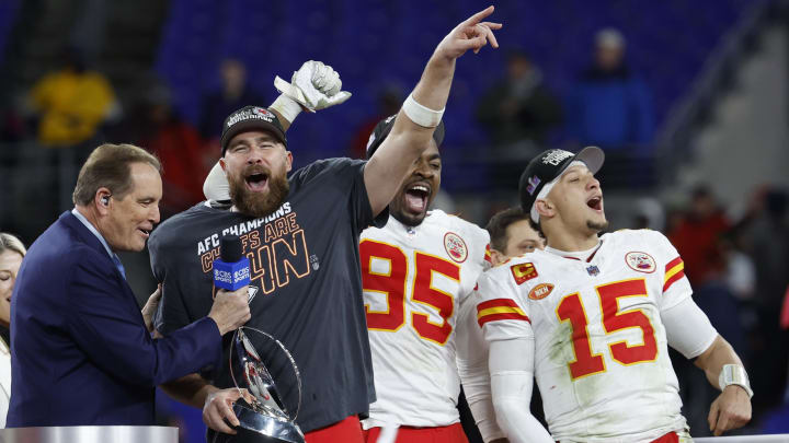 Jan 28, 2024; Baltimore, Maryland, USA; Kansas City Chiefs tight end Travis Kelce (M) celebrates with the Lamar Hunt trophy next to Chiefs defensive tackle Chris Jones (95) and Chiefs quarterback Patrick Mahomes (15) while speaking with CBS broadcaster Jim Nantz (L) after the Chiefs' game against the Baltimore Ravens in the AFC Championship football game at M&T Bank Stadium. Mandatory Credit: Geoff Burke-USA TODAY Sports