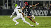 Aug 28, 2025; Orlando, Florida, USA; Jacksonville State Gamecocks quarterback Gavin Wimsatt (2) carries the ball as UCF Knights defensive back Demari Henderson (8) moves in during the second half at Acrisure Bounce House. Mandatory Credit: Mike Watters-Imagn Images