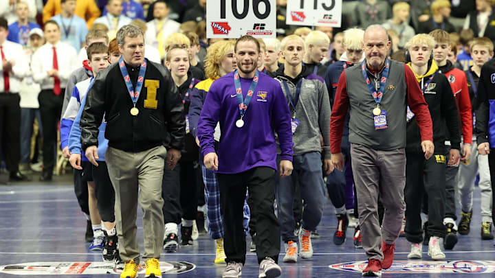 Feb 22, 2025; Des Moines, Iowa, USA; From left: Iowa coach Tom Brands, Northern Iowa coach Doug Schwab and Iowa State coach Kevin Dresser lead the Grand March at the state boys wrestling tournament at Wells Fargo Arena.