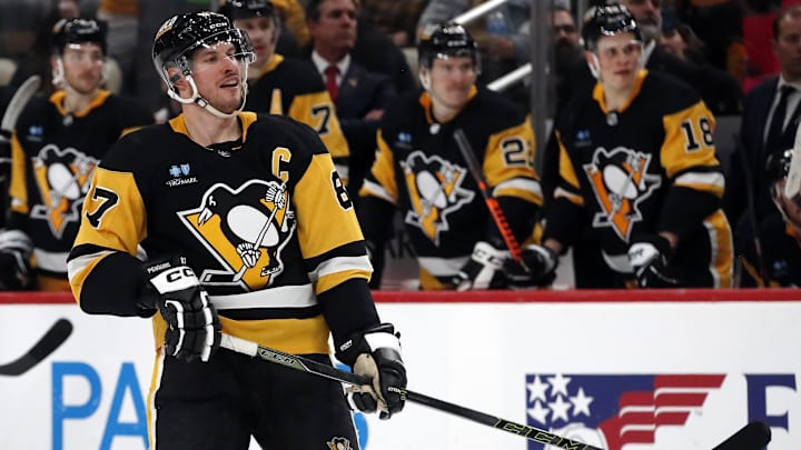 Mar 26, 2024; Pittsburgh, Pennsylvania, USA;  Pittsburgh Penguins center Sidney Crosby (87) reacts as he looks on as his shot goes into an empty Carolina Hurricanes net for a gaol during the third period at PPG Paints Arena. Pittsburgh won 4-1. Mandatory Credit: Charles LeClaire-Imagn Images