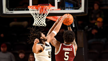 Jan 15, 2025; Nashville, Tennessee, USA;  Vanderbilt Commodores forward Devin McGlockton (99) blocks the shot of South Carolina Gamecocks forward Nick Pringle (5) during the second half at Memorial Gymnasium. Mandatory Credit: Steve Roberts-Imagn Images