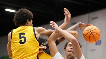 Mainland's DeAndre Newland (21) has his shot blocked by Blake's Joshua Lewis (5) and Joe Philon (1) in an FHSAA Class 5A boys basketball semifinal in Lakeland on Friday, March 6, 2024.